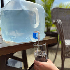 Person filling a glass with water from the 4Patriots aqua-tote