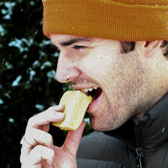 Man biting into Emergency Food Bar.