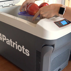 Someone placing apples inside the Freedom fridge